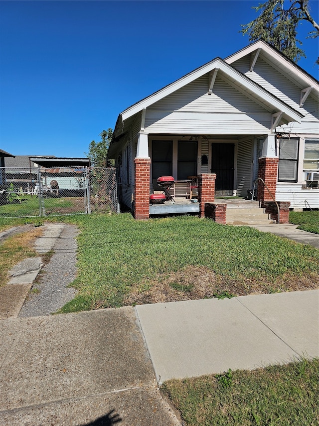 view of front of home featuring covered porch and a front yard