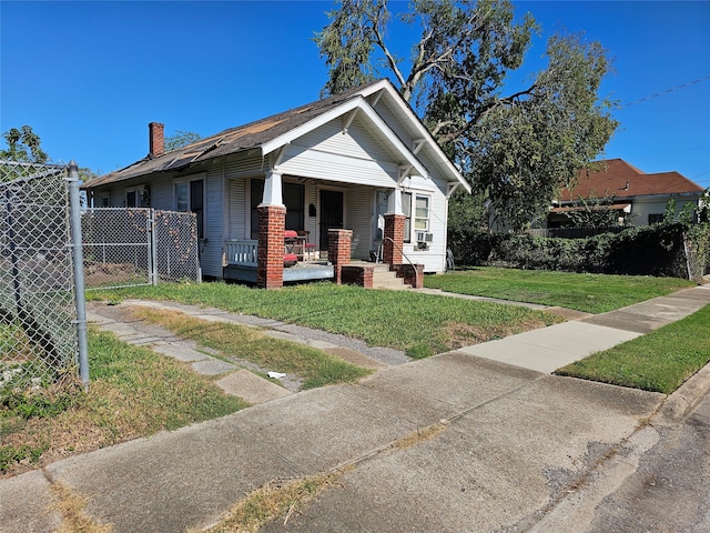 bungalow featuring a front yard and a porch