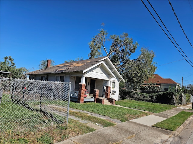 bungalow-style home with a porch and a front yard