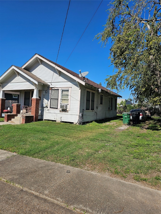 view of front of house featuring a front yard and cooling unit