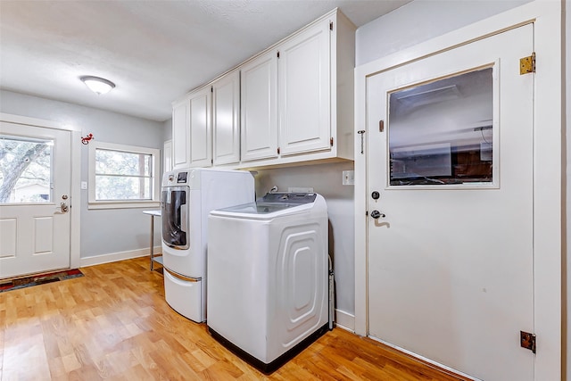 washroom featuring cabinets, independent washer and dryer, and light wood-type flooring