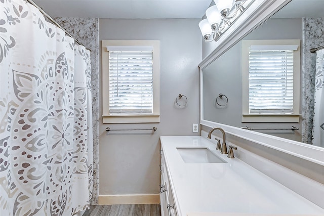 bathroom featuring vanity, wood-type flooring, and walk in shower