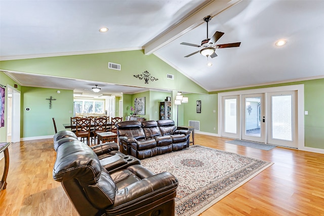 living room with lofted ceiling with beams, crown molding, ceiling fan, and light hardwood / wood-style floors