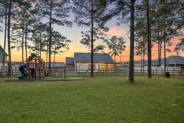 view of home's community with a playground and a yard