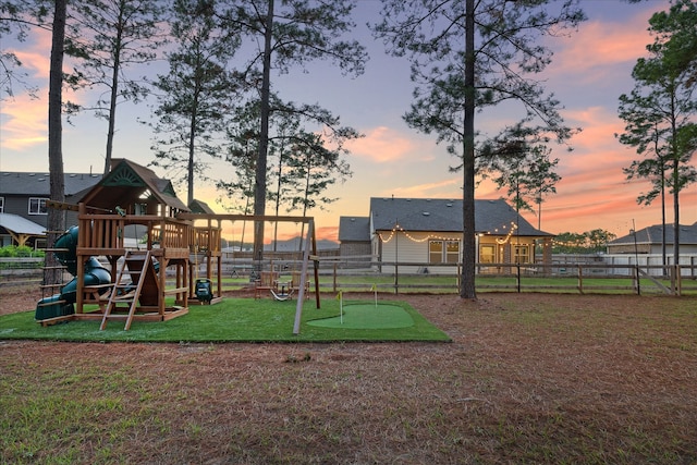 playground at dusk with a lawn