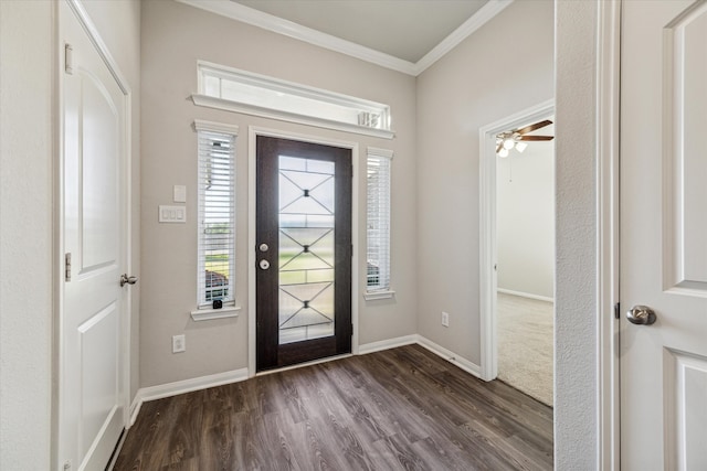 foyer with ornamental molding, ceiling fan, and dark wood-type flooring