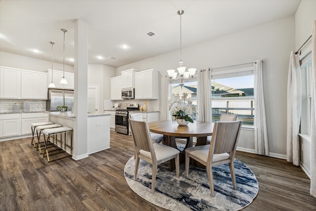 dining space featuring a chandelier and dark hardwood / wood-style flooring