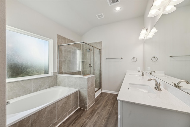 bathroom featuring vanity, wood-type flooring, lofted ceiling, and plus walk in shower