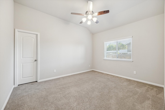 spare room with light carpet, vaulted ceiling, and ceiling fan