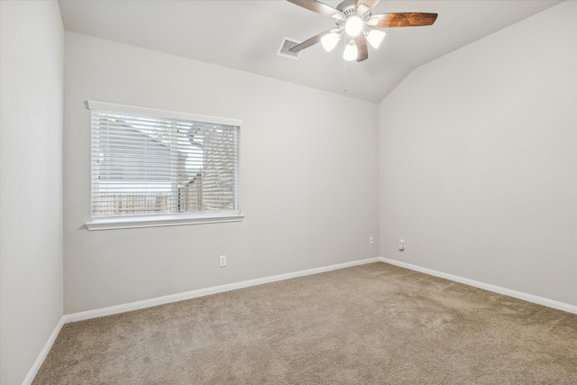 carpeted spare room with ceiling fan and lofted ceiling