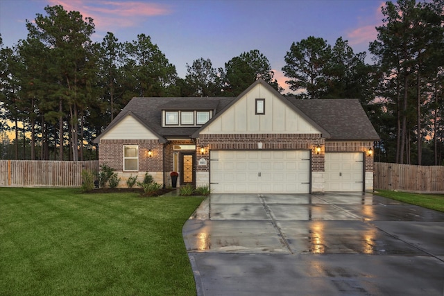 view of front of house with a garage and a lawn