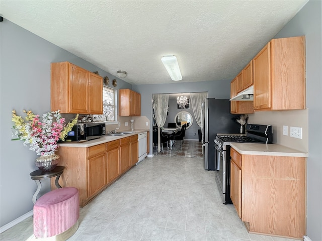 kitchen featuring sink, appliances with stainless steel finishes, and a textured ceiling