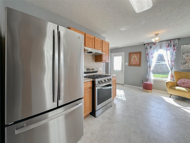 kitchen featuring a textured ceiling and stainless steel appliances