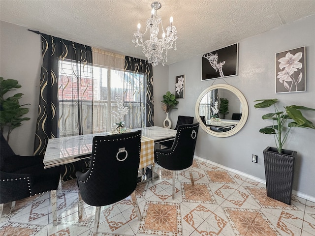 dining space with a chandelier, light tile patterned floors, and a textured ceiling