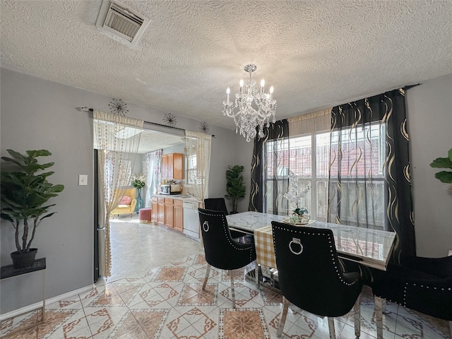 dining space featuring a chandelier and a textured ceiling