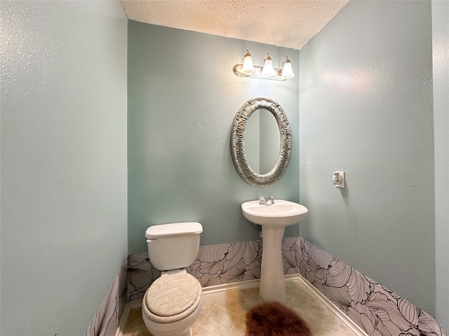 bathroom featuring sink, tile patterned flooring, a textured ceiling, and toilet