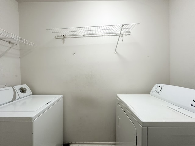 clothes washing area with washing machine and clothes dryer