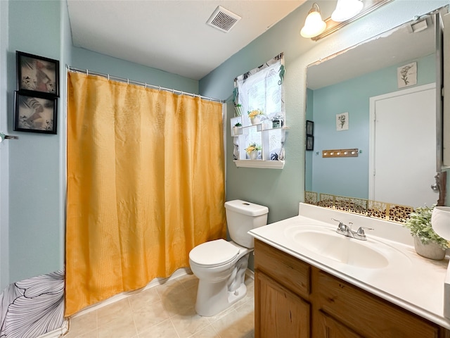 bathroom with tile patterned floors, vanity, and toilet