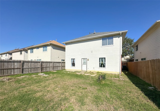 back of property featuring a lawn