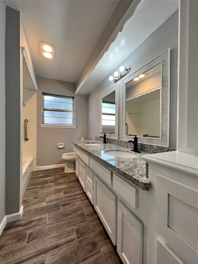 bathroom featuring toilet, vanity, and hardwood / wood-style flooring