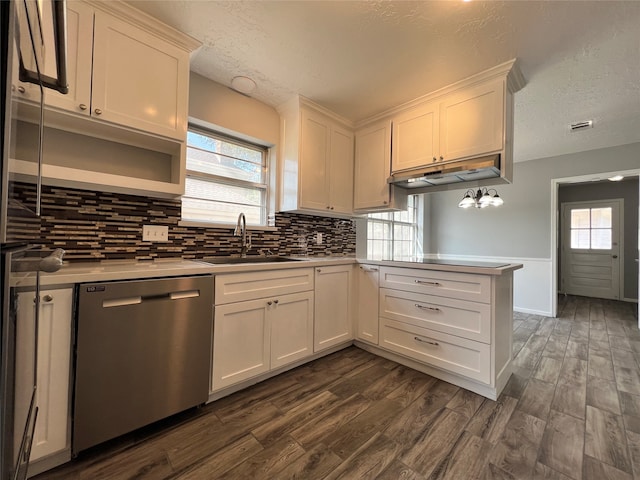 kitchen featuring dishwasher, kitchen peninsula, dark hardwood / wood-style floors, and sink