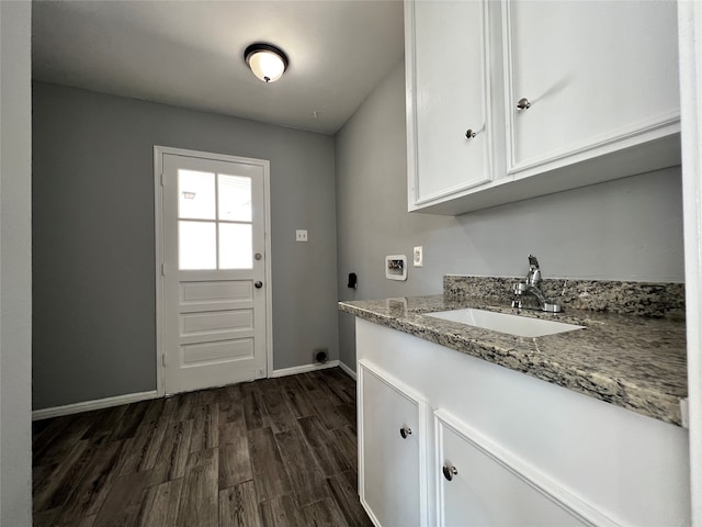 laundry room with electric dryer hookup, cabinets, sink, washer hookup, and dark hardwood / wood-style flooring