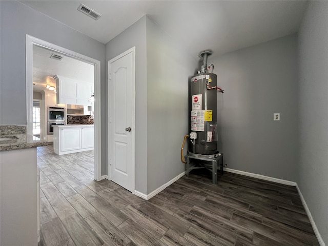 interior space featuring dark wood-type flooring and water heater