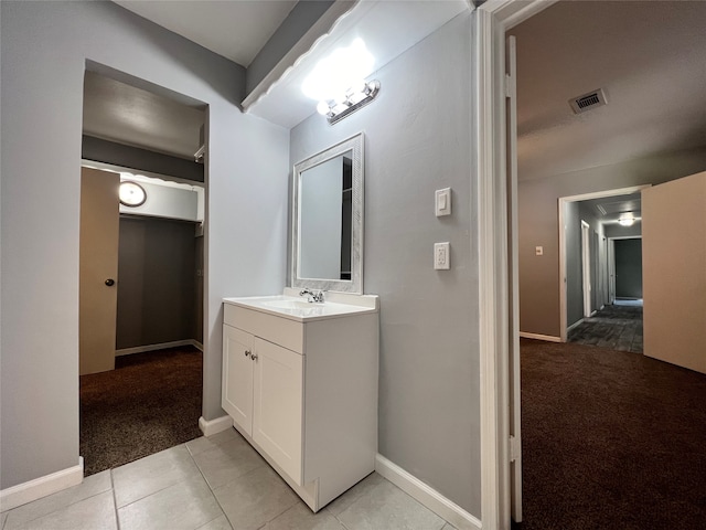 bathroom with tile patterned flooring and vanity