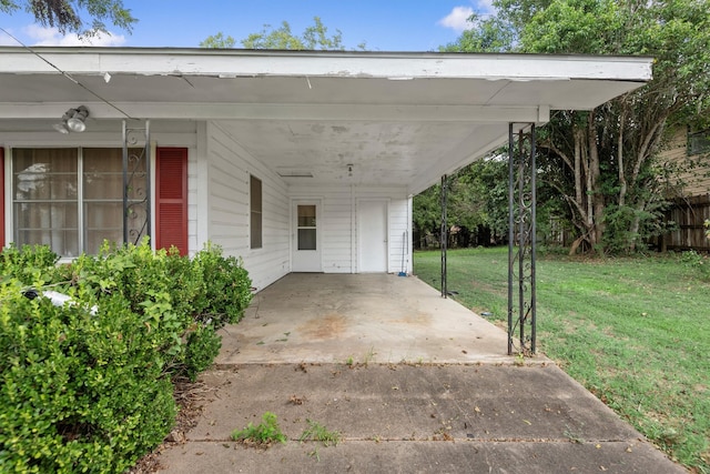 view of car parking with a yard and a carport