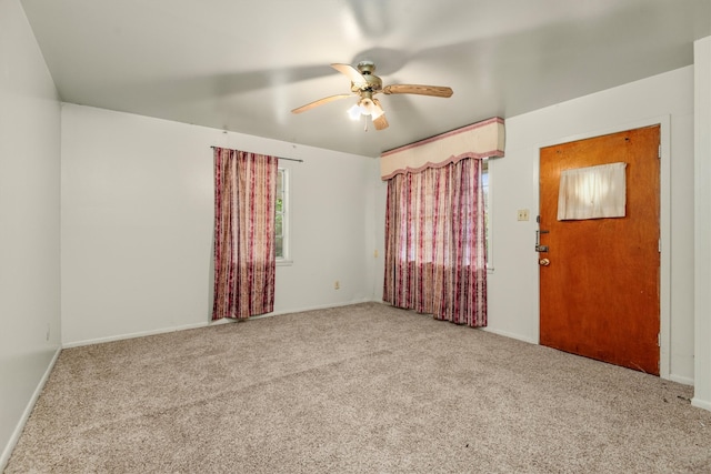 unfurnished room featuring ceiling fan and carpet floors