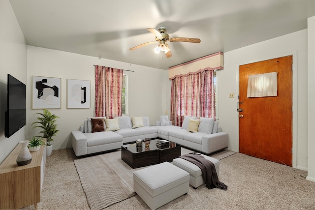 carpeted living room with ceiling fan