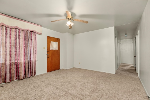 unfurnished room with ceiling fan and light carpet