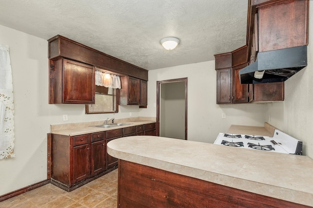 kitchen featuring a textured ceiling, white range, dark brown cabinetry, exhaust hood, and sink