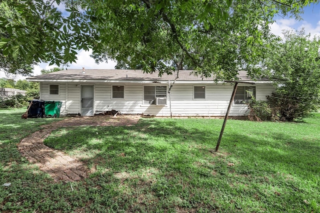 rear view of house with a yard