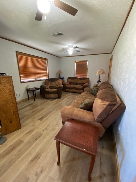 living room with ceiling fan and light hardwood / wood-style floors