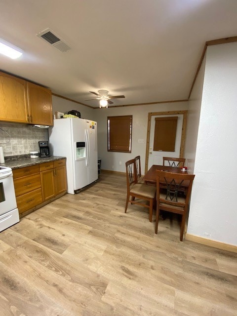 kitchen with backsplash, ceiling fan, white appliances, and light wood-type flooring