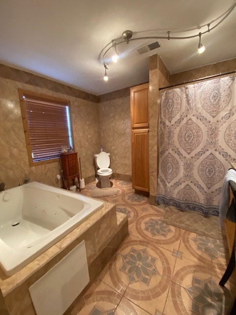 bathroom with tiled bath and toilet