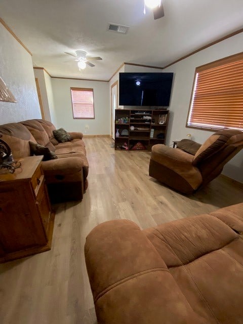 living room featuring ornamental molding, ceiling fan, and light hardwood / wood-style floors