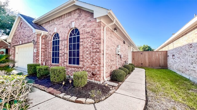 view of side of home featuring a garage