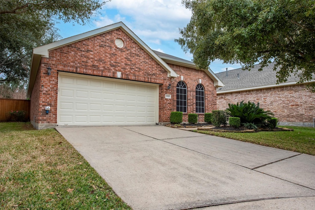 view of property featuring a front lawn and a garage