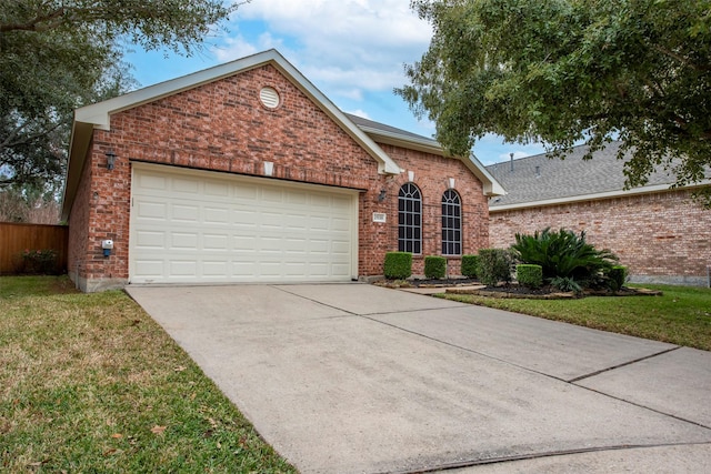 view of property featuring a front lawn and a garage