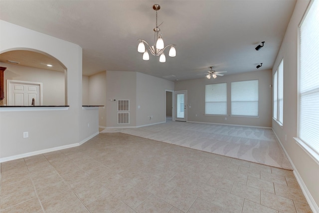 spare room with light tile patterned flooring and ceiling fan with notable chandelier