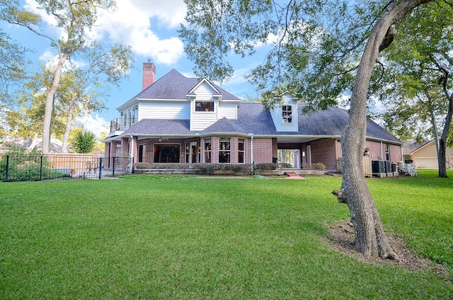 view of front of home with a balcony and a front yard