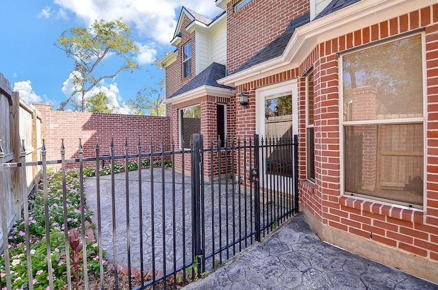 view of gate featuring a patio