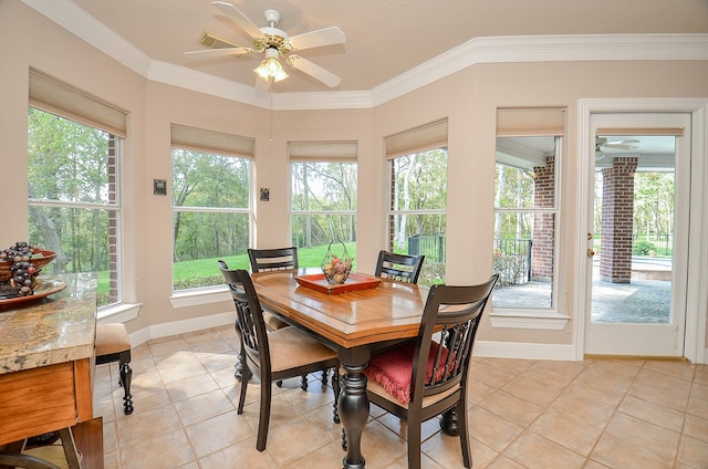 dining room with light tile patterned flooring, plenty of natural light, and ornamental molding