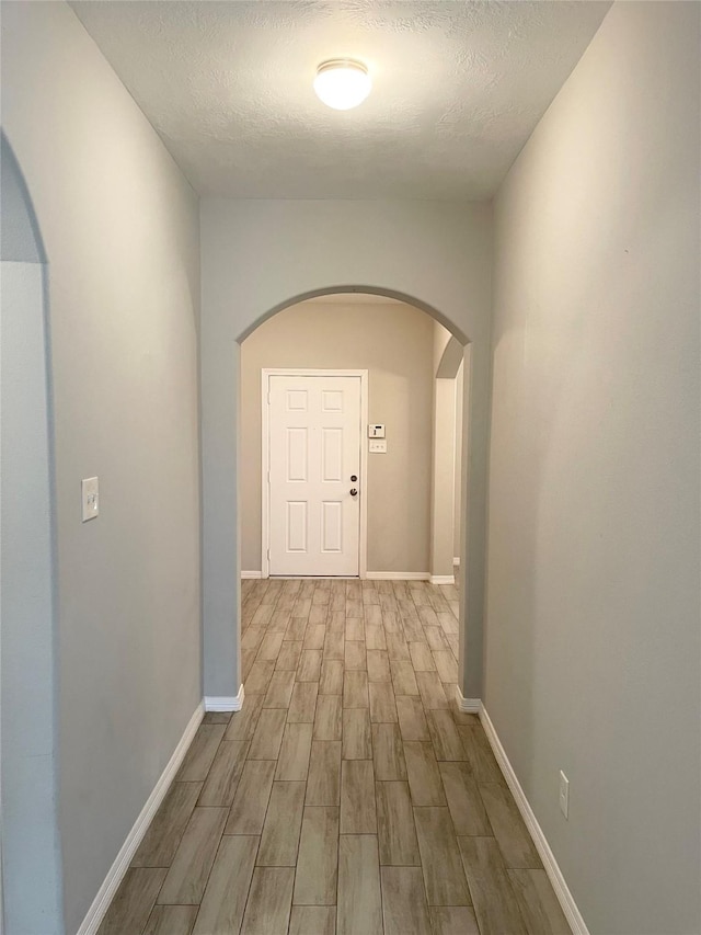 hallway featuring a textured ceiling