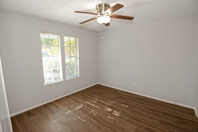 spare room featuring ceiling fan, dark hardwood / wood-style floors, and a textured ceiling