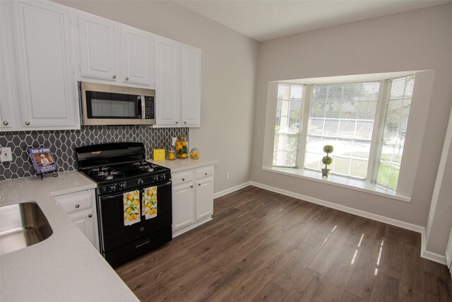 kitchen featuring decorative backsplash, white cabinetry, black range with gas cooktop, and dark wood-type flooring