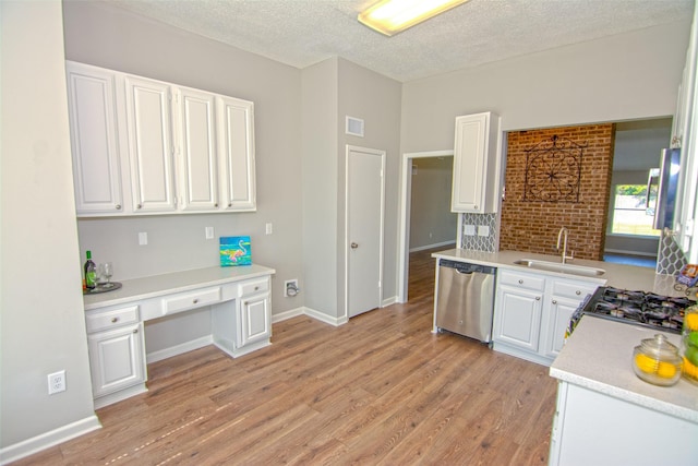 kitchen featuring white cabinetry, light hardwood / wood-style floors, a textured ceiling, stainless steel dishwasher, and sink