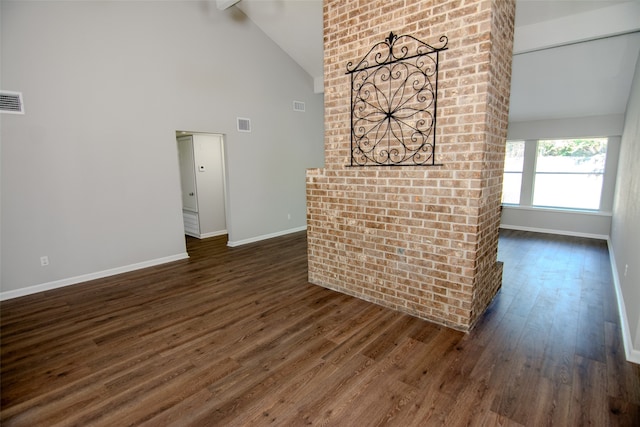 unfurnished living room featuring high vaulted ceiling, dark hardwood / wood-style flooring, and beam ceiling